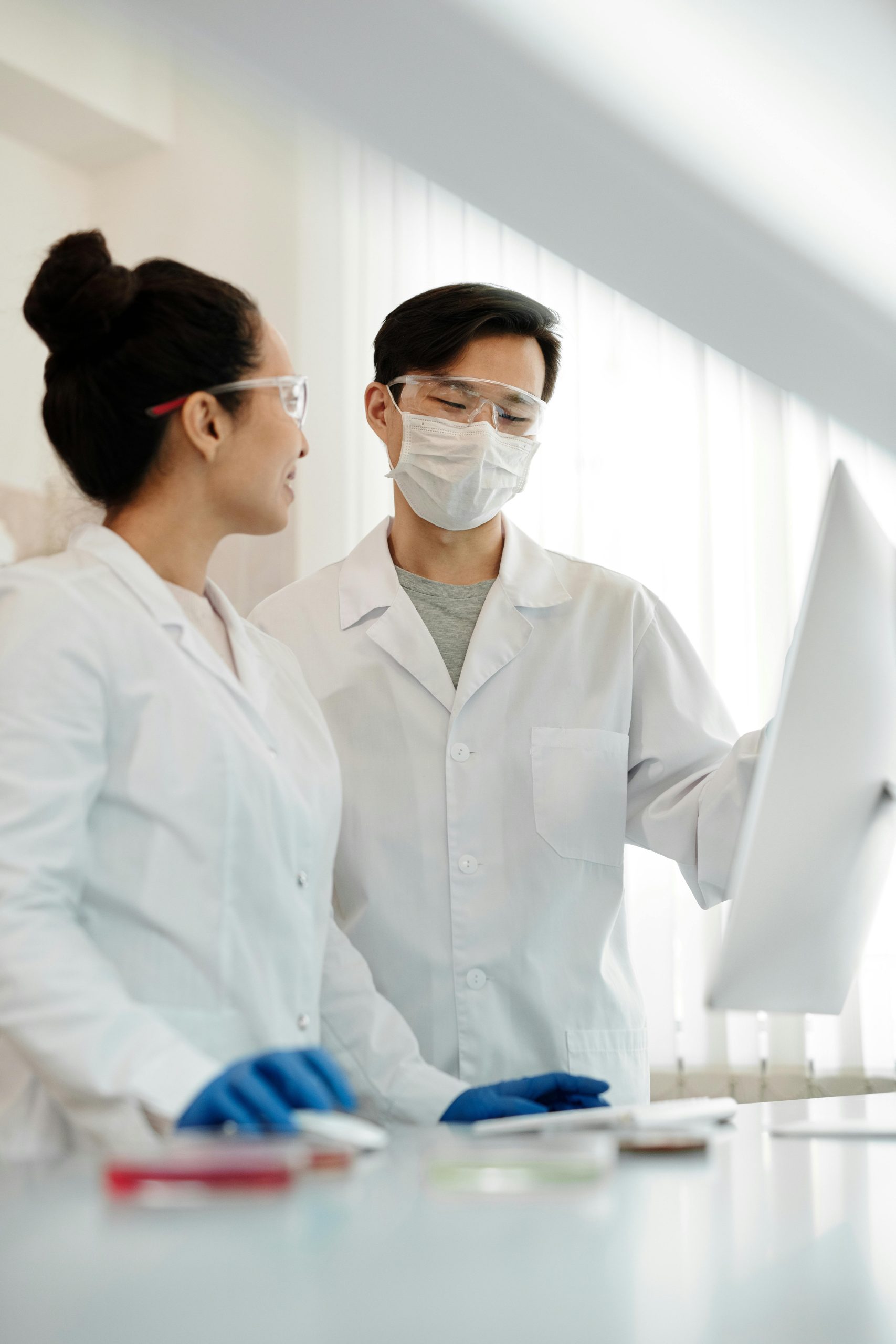 Two scientists discussing research results in a laboratory environment.